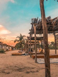 a sandy beach with palm trees and palm trees at Hotel Fenix Beach Cartagena in Tierra Bomba