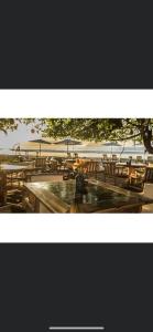 a group of tables and chairs with people sitting on them at LA DOLCE VITA - on the Beach - Samara in Sámara