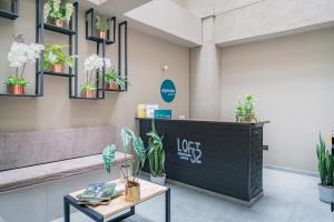 a waiting room with a bench and potted plants at Loft 32 Medellín Living in Medellín