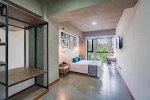 a bedroom with a bed and a large window at Loft 32 Medellín Living in Medellín +27 photos