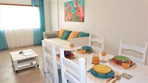 a living room with a table and a couch at ALTIUM Cabanas in Cabanas de Tavira +24 photos