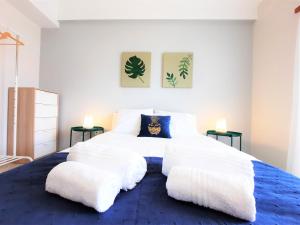 a bedroom with a large bed with two white pillows at ALTIUM Cabanas in Cabanas de Tavira