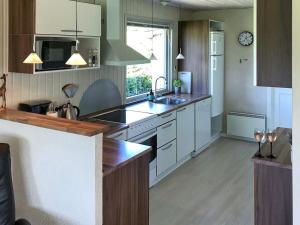 a kitchen with white cabinets and a counter top at Two-Bedroom Holiday home in Aabenraa 2 in Aabenraa