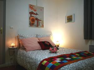 a bedroom with a bed with flowers on it at NICE APPARTEMENT in Amboise