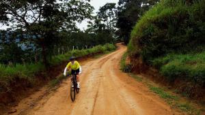 a man riding a bike down a dirt road at Hotel Cacique Chalalá in Charalá