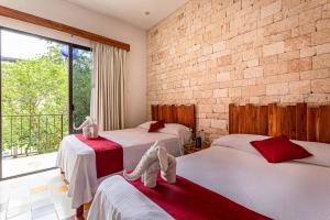 ein Schlafzimmer mit zwei Betten mit Handtüchern darauf in der Unterkunft Hotel Boutique Casa Hipil in Valladolid