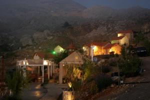 a group of houses on a hill at night at Soha Village Resort in Fālūghā