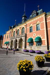 a large building with flowers in front of it at Haparanda Stadshotell in Haparanda