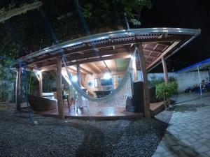 a hammock under a gazebo at night at Rancho Velho Tropeiro in São Francisco do Sul