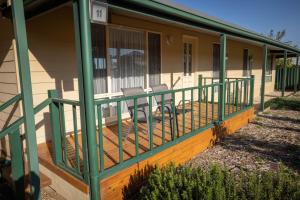 a porch of a house with two chairs on it at Park View, Maitland in Maitland