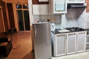 a kitchen with a refrigerator and a stove at Panadura Top view - ACCEDE Apartment in Panadura