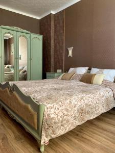 a bedroom with a large bed and a mirror at Boutique House Belevi in Nesebar