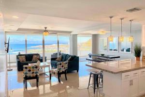 a kitchen and living room with a view of the ocean at Beachfront Condo close Puerto Nuevo, Papas, and Valle de Guadalupe in Rosarito