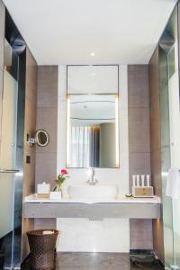 a bathroom with a sink and a mirror at Cachet Boutique Kunming Artime in Kunming