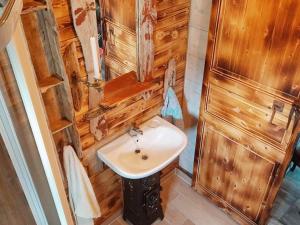 a bathroom with a sink and a wooden wall at 11 person holiday home in Syvde in Myklebost +41 photos