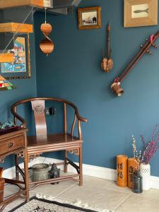 a blue wall with a wooden chair in a room at Westwaterhead in Kingsbridge