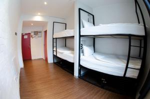 two bunk beds in a room with a hallway at 91 Loop Boutique Hostel in Cape Town
