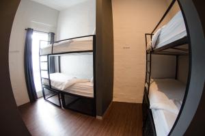 two bunk beds in a room with a mirror at 91 Loop Boutique Hostel in Cape Town