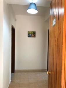 a hallway with a door and a picture on the wall at Soleado Apartments Caprioli-Palinuro in Palinuro