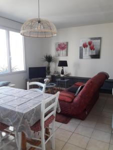 a living room with a couch and a table at Gite 2 personnes in Plonévez-Porzay