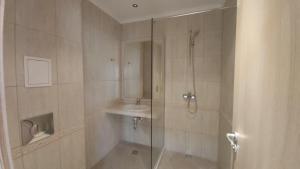 A bathroom at By the Waves luxury beach apartment