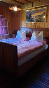 a bedroom with two beds in a room at Almhütte Prem 1 in Ramingstein +14 photos