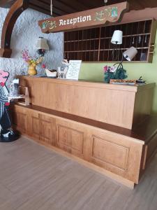 a reception desk in a restaurant with a counter at HOTEL WALDHORN in Jungholz