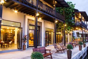 - une terrasse avec un ensemble de bancs et de tables dans l'établissement The Bank River House Ayutthaya, à Ban Yai (1)