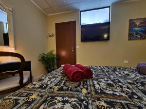 a red pillow laying on a bed in a room at Domus Lace in Messina