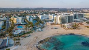 an aerial view of a beach and buildings at Anonymous Beach Hotel (Adults 16+) in Ayia Napa
