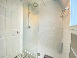 a bathroom with a shower with a glass door at St Margaret's Cottage, Edinburgh in Edinburgh +20 photos