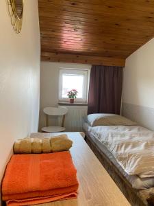 a bedroom with two beds and a window at Penzion U Martina in Mariánské Lázně