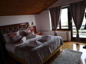 ein Schlafzimmer mit einem großen Bett in einem Zimmer mit Fenstern in der Unterkunft Apartment Gina in Opatija