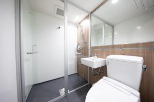 a bathroom with a toilet and a sink at Almont Hotel Nippori in Tokyo