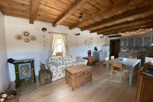 a living room with a couch and a stove at Biely domček in Devičie