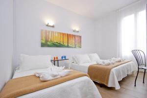Posteľ alebo postele v izbe v ubytovaní Barcelona City Hotel