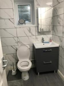 a bathroom with a toilet and a sink and a window at Ladysmith House in Plymouth +8 photos