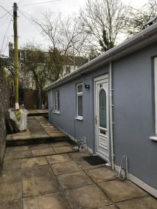 a blue house with a door and a patio at Ladysmith House in Plymouth