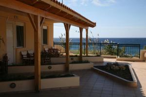 a house with a patio with a view of the ocean at Akti Damnoni in Damnoni