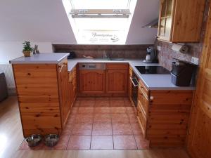 a kitchen with wooden cabinets and a skylight at Ankommen und loswandern Familien und Hundeurlaub im Hochschwarzwald Ferienwohnung Haus Maria in St. Blasien +33 photos