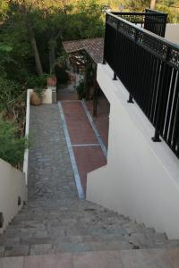 a stairway leading to a balcony with a fence at Akti Damnoni in Damnoni