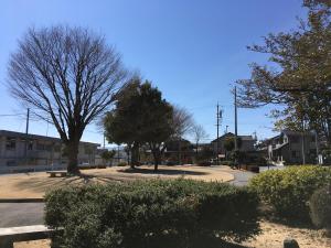 a street with trees and bushes in a town at Iida Accommodation in Iida