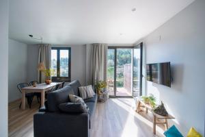a living room with a couch and a table at Apartaments Agulles de Montserrat in Monistrol