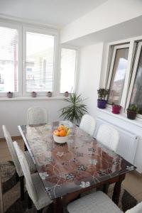 a dining room table with a bowl of fruit on it at Apartman Rastko in Nova Varoš