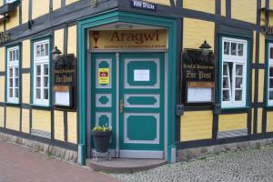 a building with a blue door on the side of it at Hotel & Restaurant Aragwi in Salzwedel