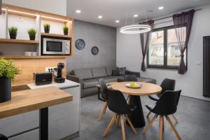 a kitchen and living room with a table and chairs at Vila Emona in Ljubljana