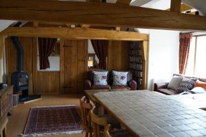 a living room with a large table and chairs at Finchden Barn in Tenterden