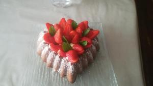 a heart shaped dessert with strawberries on a plate at La Gerbaudiere Chambres&Table d hotes proche Mont Saint Michel CUISINE MAISON in Notre-Dame-du-Touchet