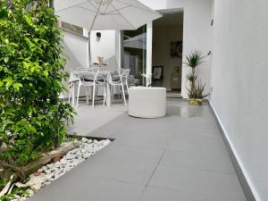 a patio with a table and an umbrella at Villa Luminosa in Torre del Lago Puccini