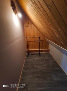 an attic hallway with a wooden ceiling and a light at Agroturystyka Pod Kołami in Myczkowce